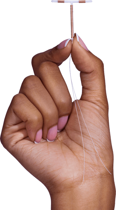 Hand holding Paragard copper IUD